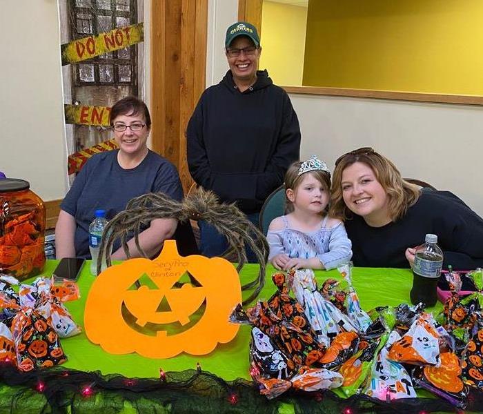 Servpro Employees sitting at Halloween decorated table