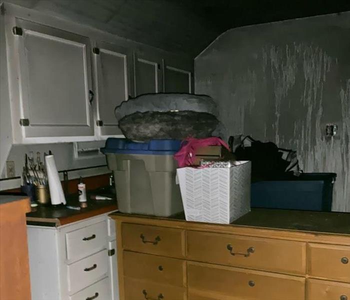 Soot on walls, cabinets, and contents.